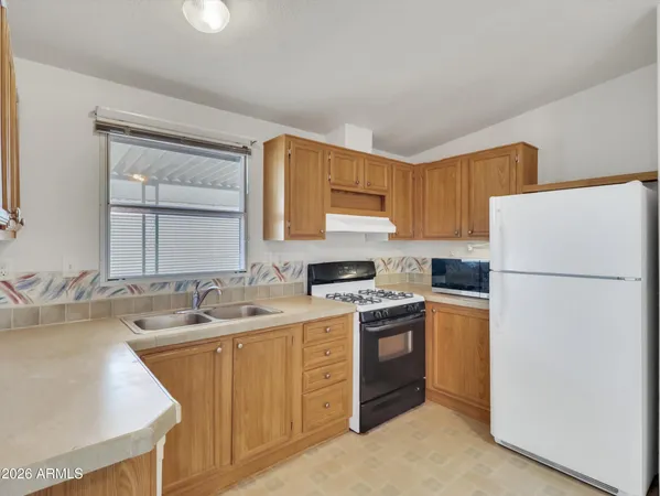 a kitchen with a sink a stove a refrigerator and a sink