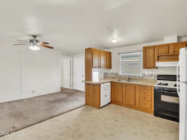 a kitchen with granite countertop a sink cabinets stainless steel appliances and a counter top space
