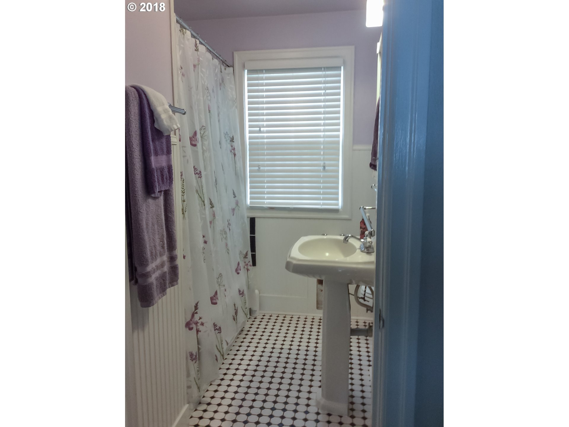 551 6th Street Springfield, OR 97477 - Photo 10 of 12 a bathroom with a sink a toilet and shower