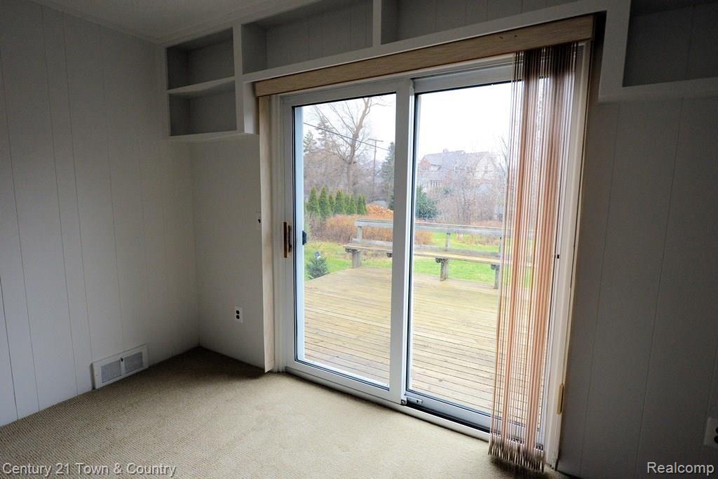 4025 Normandy Road Royal Oak, MI 48073 - Photo 17 of 35 Door wall to deck - and check out the built-in book shelves above