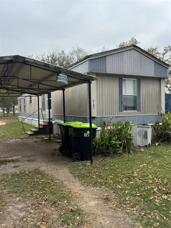 a view of a house next to a yard