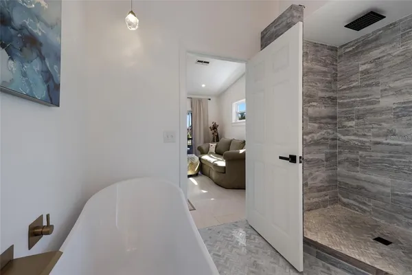 a bedroom with a bed and a couch