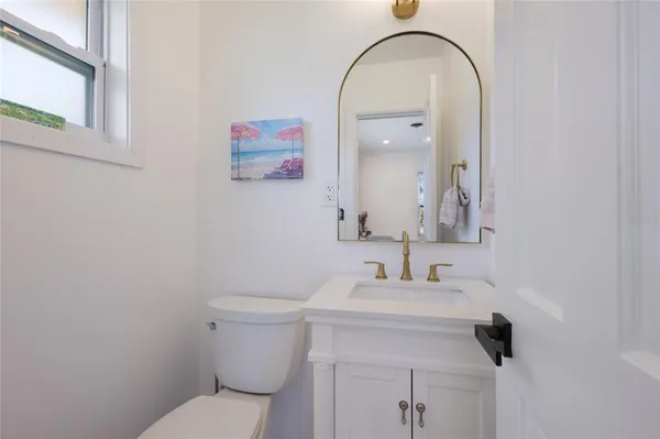 a bathroom with a granite countertop sink a mirror and vanity