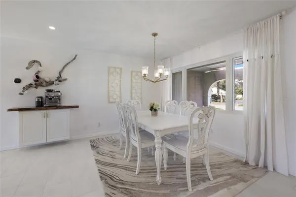 a kitchen with a sink a stove and chairs
