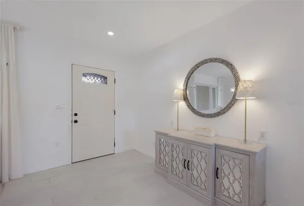 a living room with furniture and a mirror