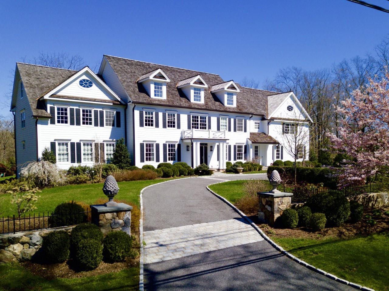 50 White Oak Shade Road New Canaan, CT 06840 - Photo 1 of 38 a front view of a house with yard and green space