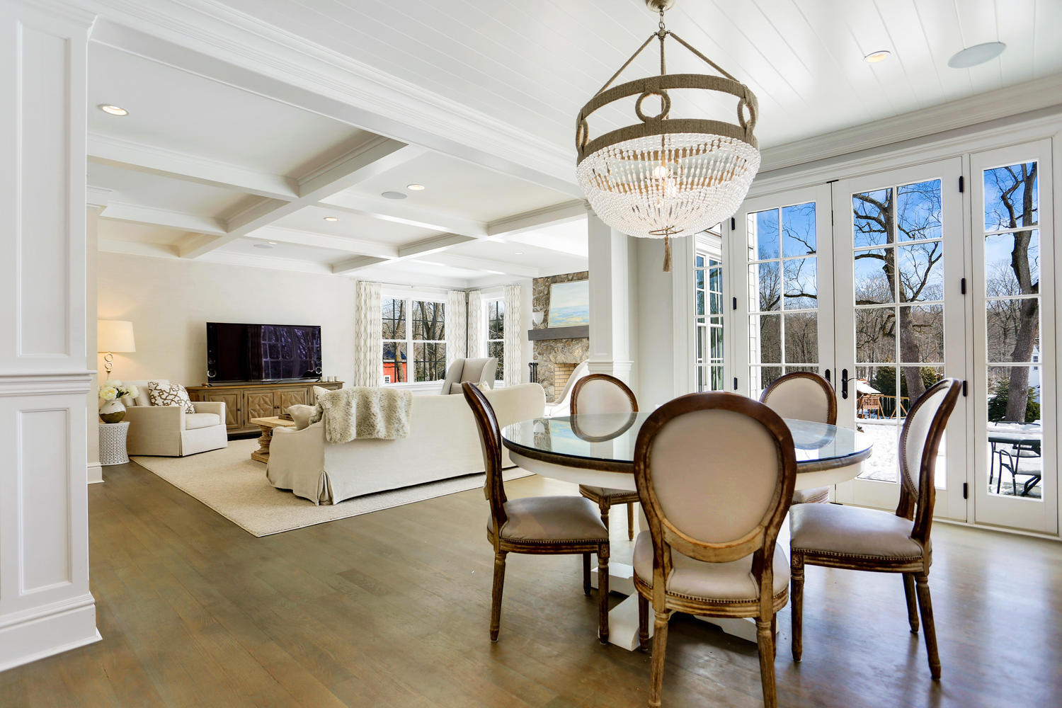 50 White Oak Shade Road New Canaan, CT 06840 - Photo 12 of 38 a living room with furniture a flat screen tv and a chandelier