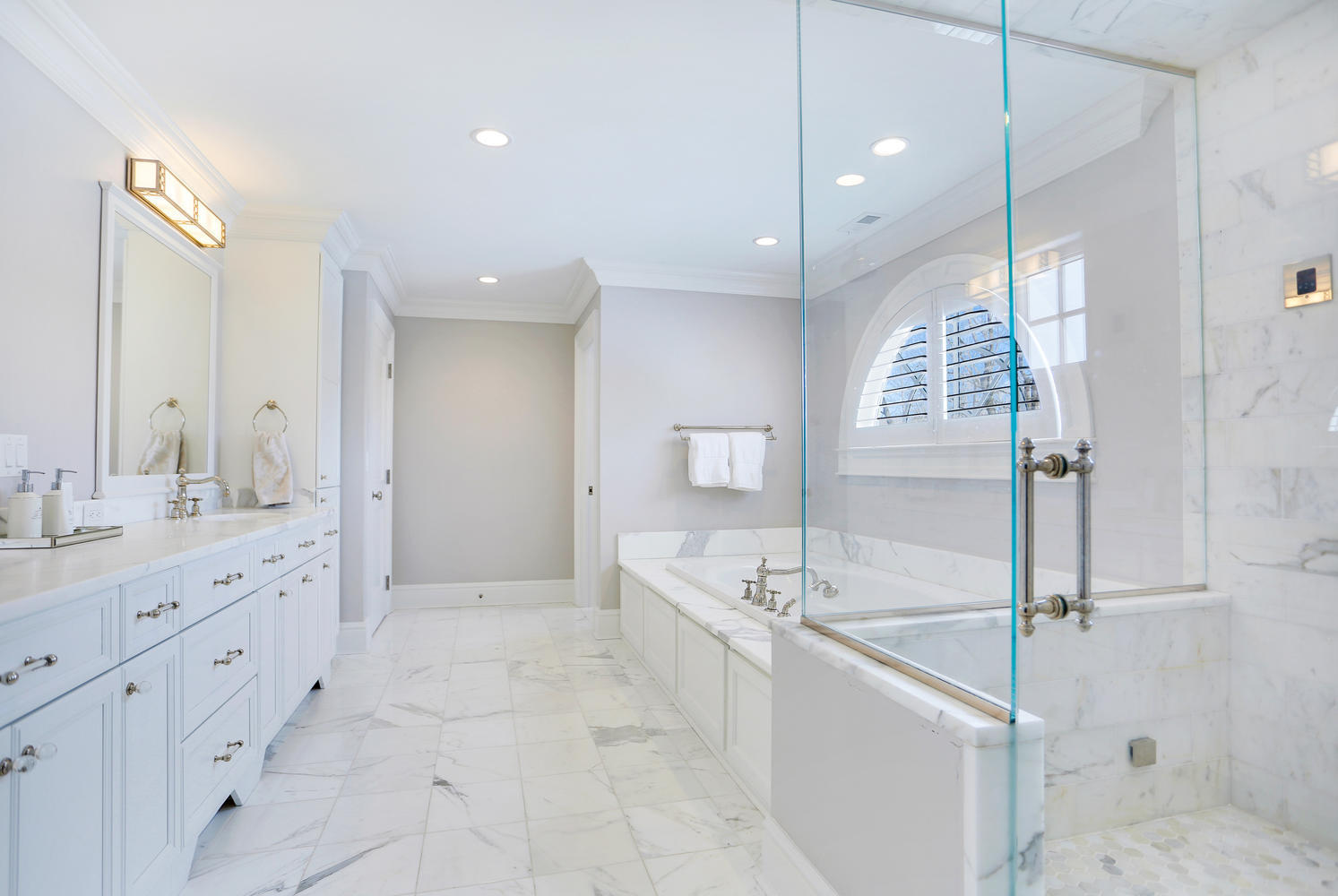 50 White Oak Shade Road New Canaan, CT 06840 - Photo 18 of 38 a spacious bathroom with a granite countertop sink a mirror a vanity and a shower