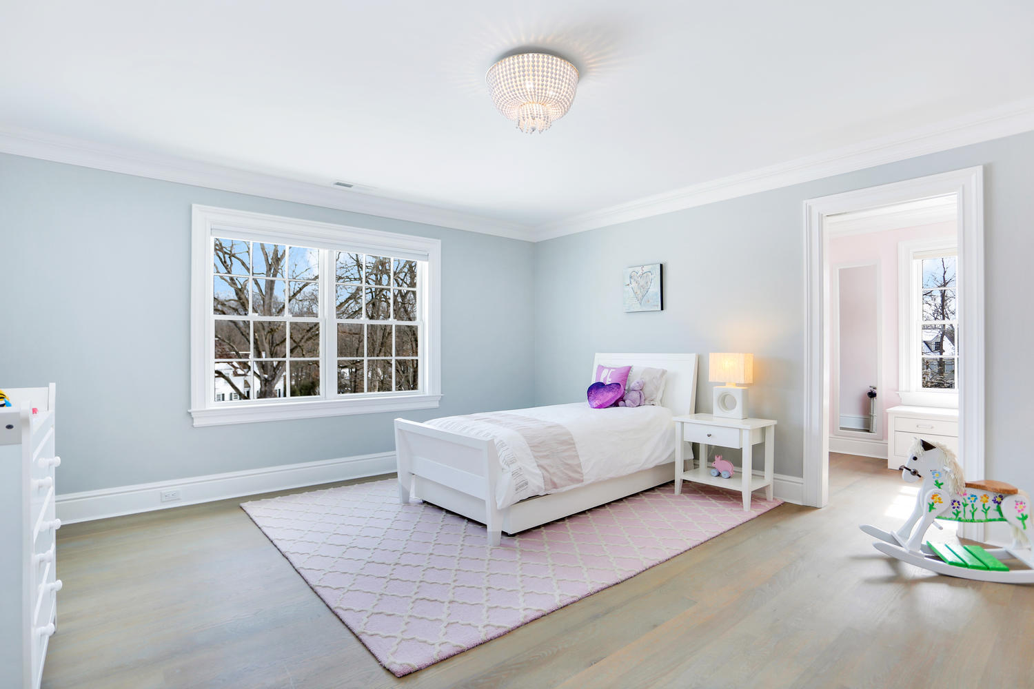 50 White Oak Shade Road New Canaan, CT 06840 - Photo 25 of 38 a bedroom with a bed chandelier and window