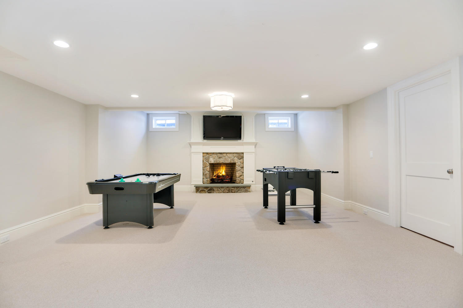 50 White Oak Shade Road New Canaan, CT 06840 - Photo 32 of 38 a living room with furniture a fireplace and a flat screen tv