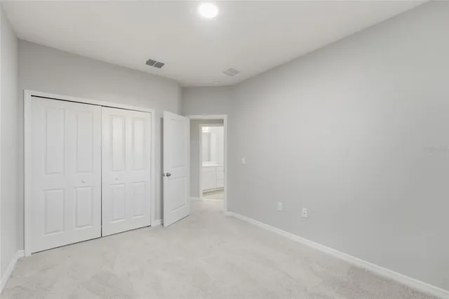 a bathroom with a sink a toilet and a large mirror