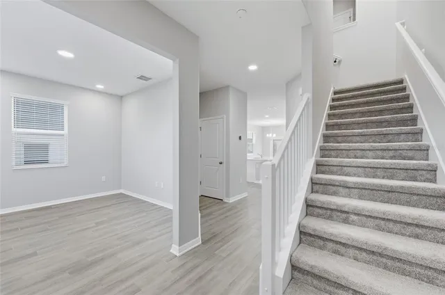 a view of entryway with wooden floor and stairs
