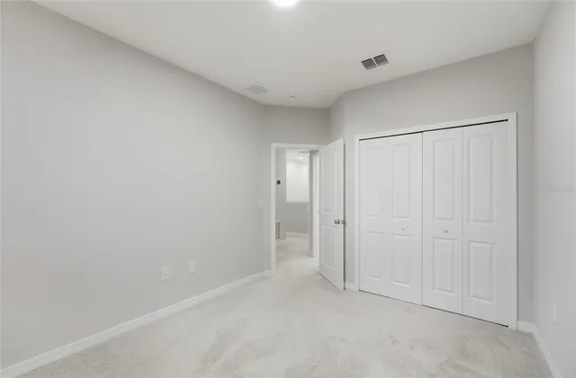 a view of a house with deck and a car parked in front of it