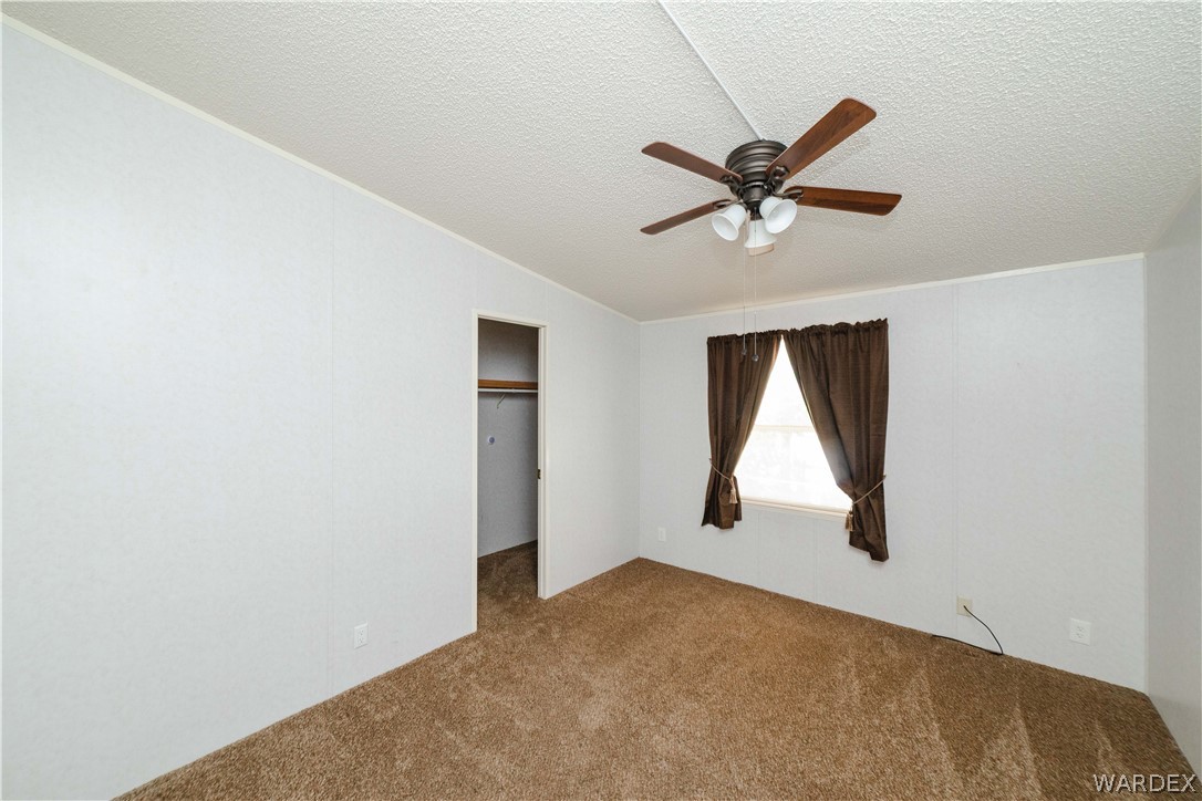3003 Hualapai Mountain Road Kingman, AZ 86401 - Photo 22 of 49 an empty room with windows and fan