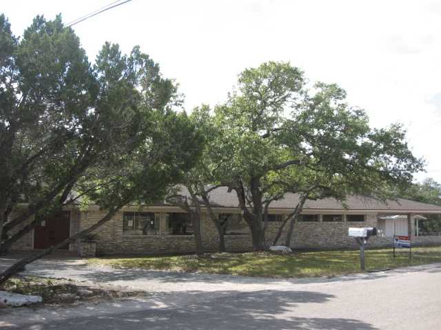 9855 Weir Loop Circle Austin, TX 78736 - Photo 1 of 1 a front view of house with yard and trees