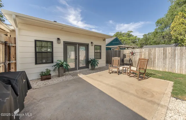 a view of a patio with couches table and chairs and potted plants