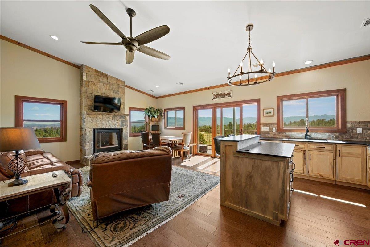 234 Thistle Drive Montrose, CO 81403 - Photo 15 of 39 a living room with furniture a fireplace and a flat screen tv