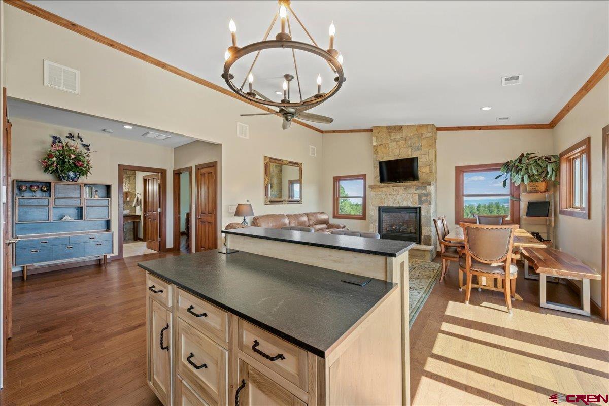 234 Thistle Drive Montrose, CO 81403 - Photo 17 of 39 a kitchen with furniture a chandelier and a view of living room