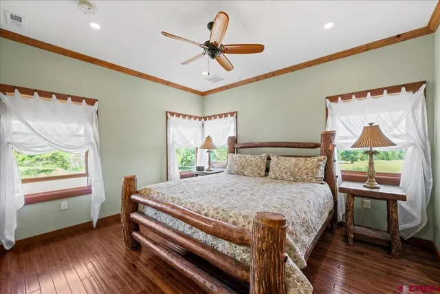 a bedroom with a bed and a large window