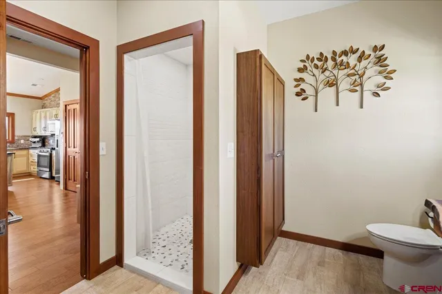 a bathroom with a toilet and a shower