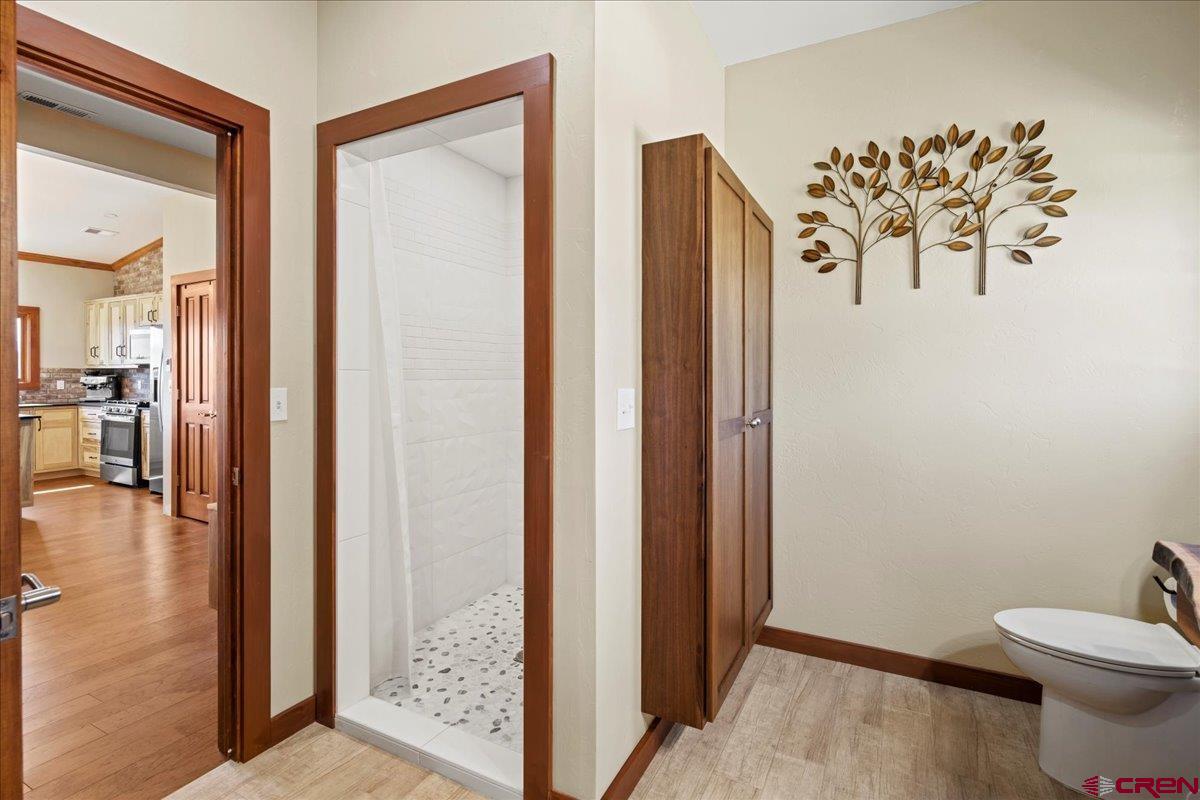 234 Thistle Drive Montrose, CO 81403 - Photo 24 of 39 a bathroom with a toilet and a shower