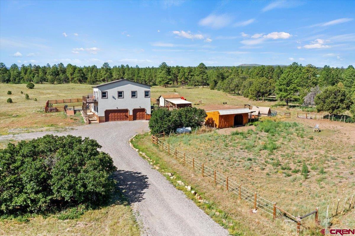 234 Thistle Drive Montrose, CO 81403 - Photo 26 of 39 aerial view of a house with a garden and trees