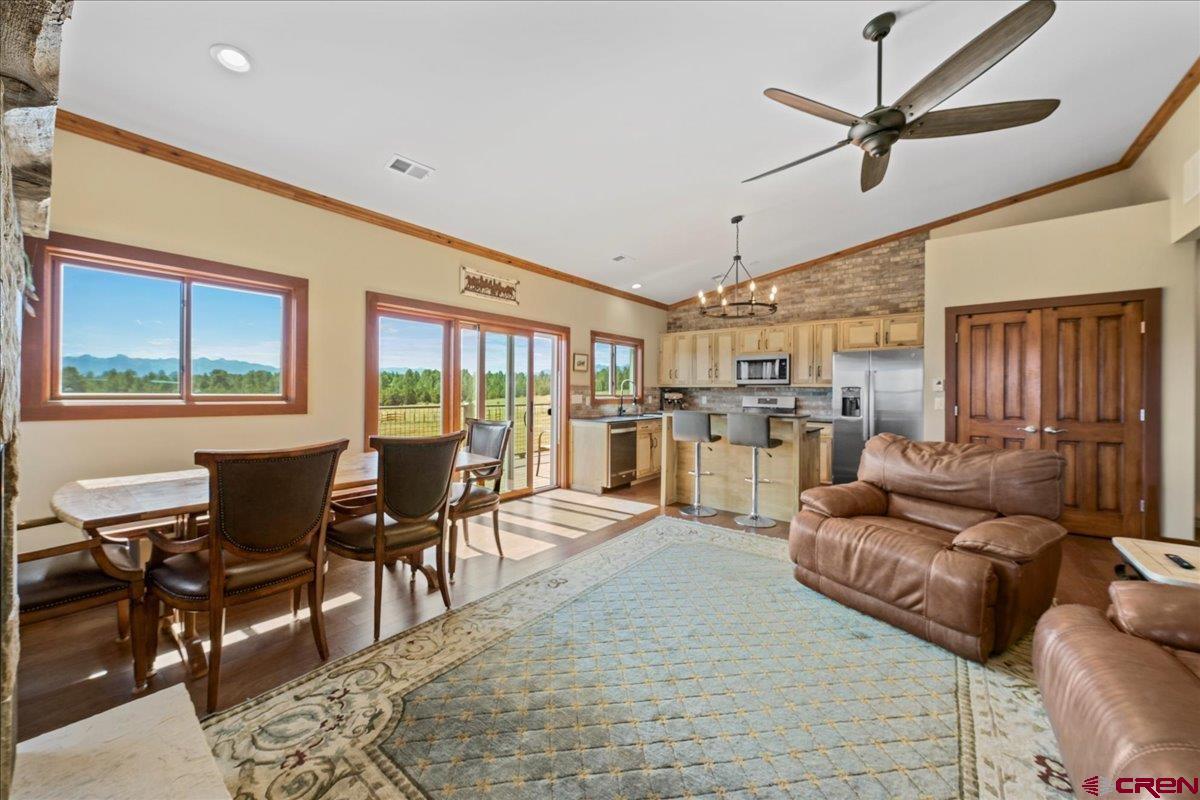 234 Thistle Drive Montrose, CO 81403 - Photo 31 of 39 a living room with furniture kitchen view and a large window