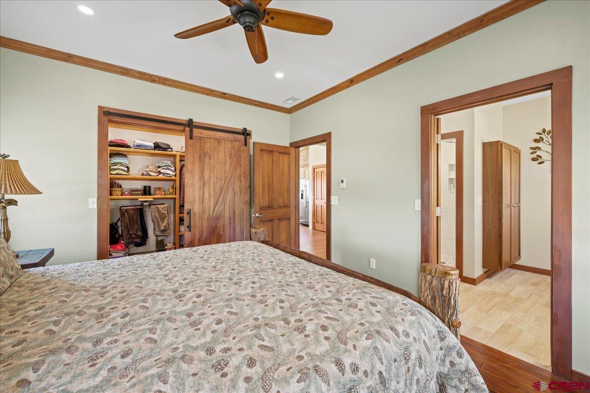 234 Thistle Drive Montrose, CO 81403 - Photo 32 of 39 a bed room with a bed and a walk in closet