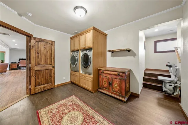 a view of a livingroom with furniture and staircase