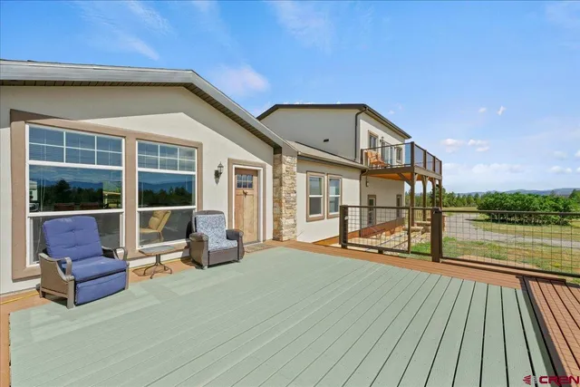 a view of swimming pool with seating space and ocean view