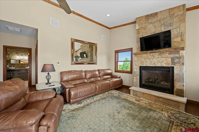 a living room with furniture a flat screen tv and a fireplace
