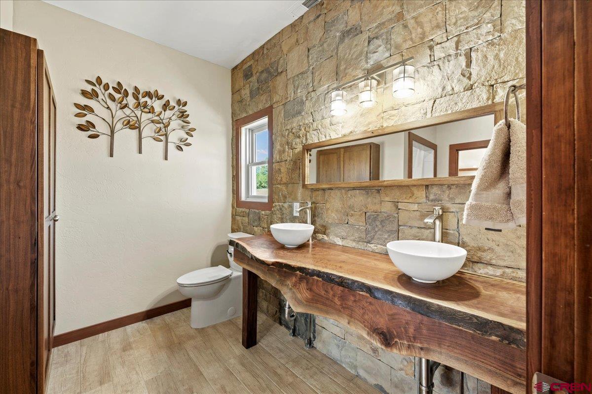 234 Thistle Drive Montrose, CO 81403 - Photo 9 of 39 a bathroom with a granite countertop sink and a mirror