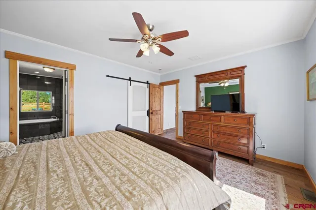 a bedroom with a large bed and a chandelier