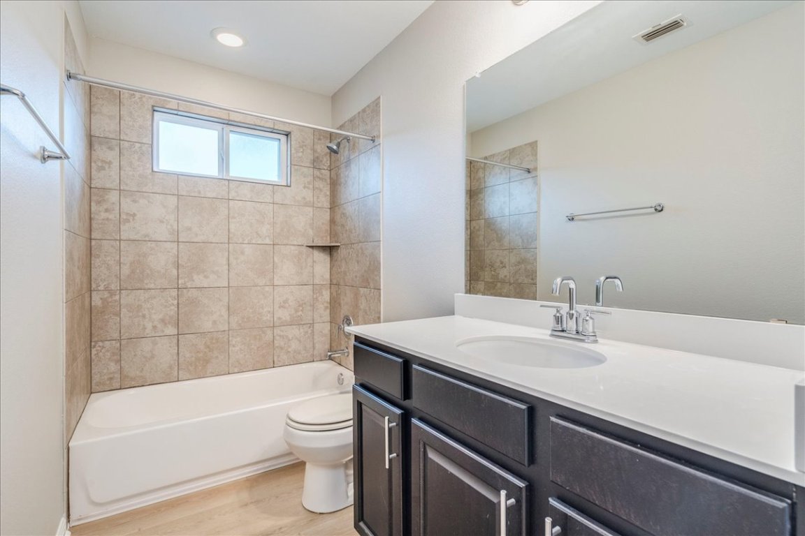 10317 Laurie Lane Austin, TX 78747 - Photo 11 of 35 a bathroom with a sink a toilet and bathtub