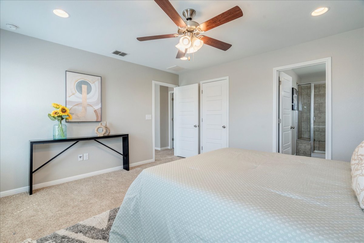 10317 Laurie Lane Austin, TX 78747 - Photo 14 of 35 Bedroom with recessed lighting, light colored carpet, ceiling fan, and ensuite bath