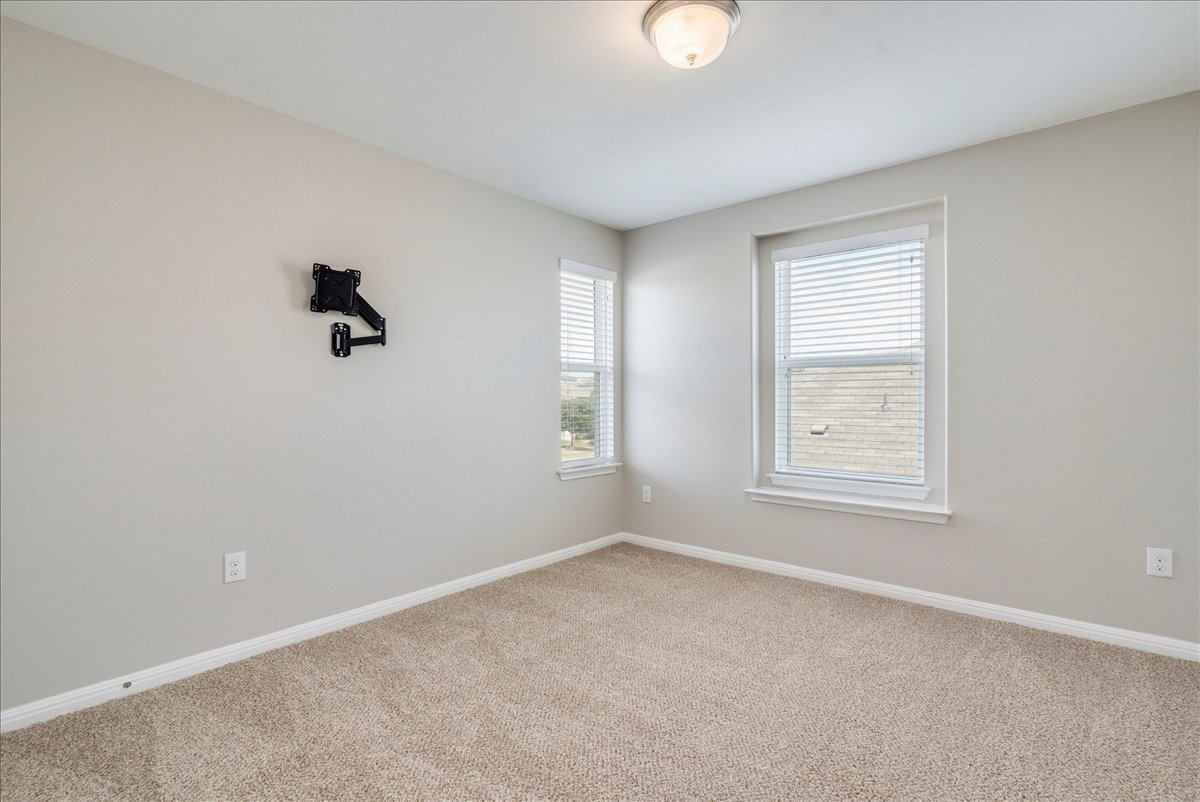 10317 Laurie Lane Austin, TX 78747 - Photo 17 of 35 Empty room featuring baseboards and carpet floors