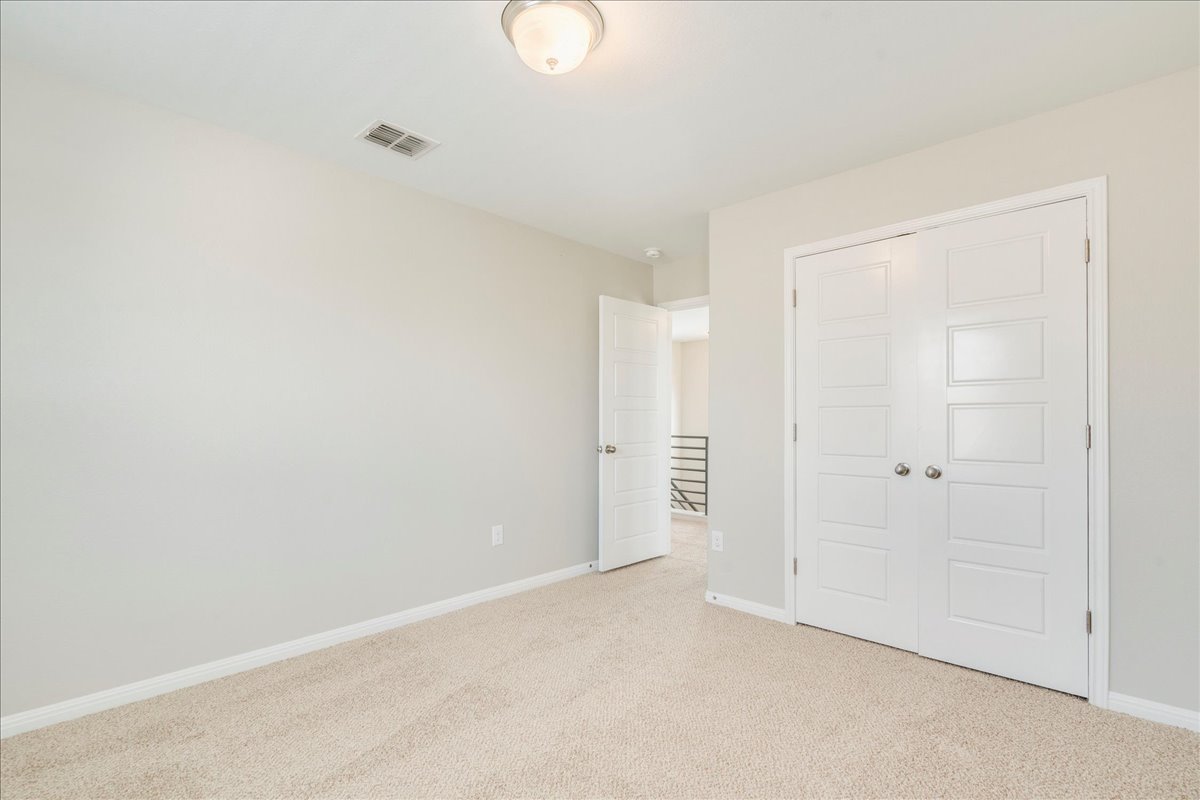 10317 Laurie Lane Austin, TX 78747 - Photo 18 of 35 Unfurnished bedroom featuring light carpet and a closet