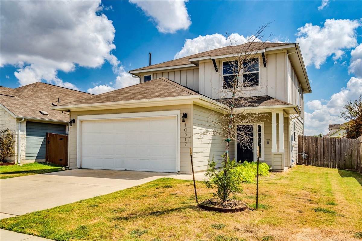 10317 Laurie Lane Austin, TX 78747 - Photo 31 of 35 View of front of house featuring board and batten siding, a garage, driveway, and roof with shingles