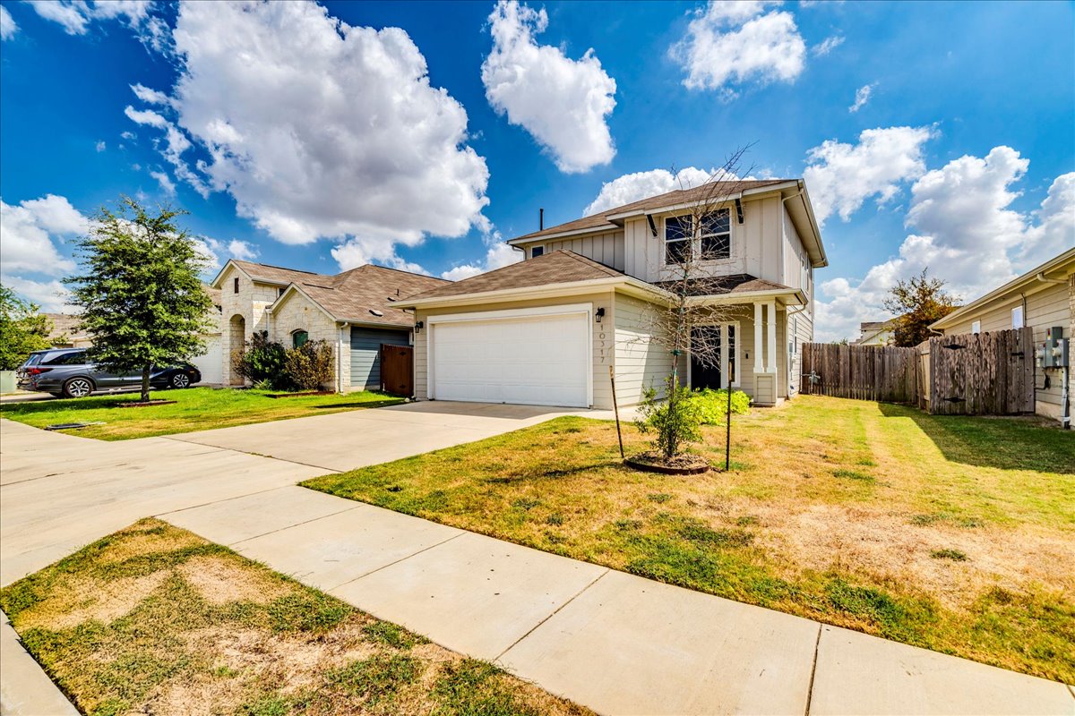 10317 Laurie Lane Austin, TX 78747 - Photo 33 of 35 Traditional-style house featuring concrete driveway, a garage, and board and batten siding