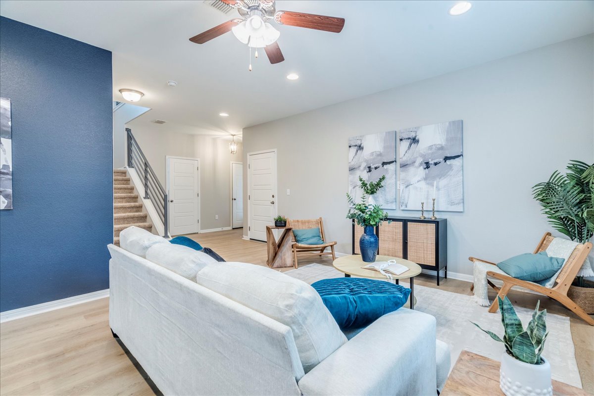 10317 Laurie Lane Austin, TX 78747 - Photo 8 of 35 Living room with stairs, light wood-style floors, ceiling fan, and recessed lighting