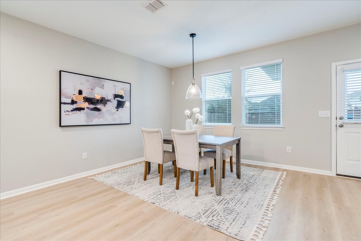 10317 Laurie Lane Austin, TX 78747 - Photo 10 of 35 Dining room featuring baseboards and light wood finished floors