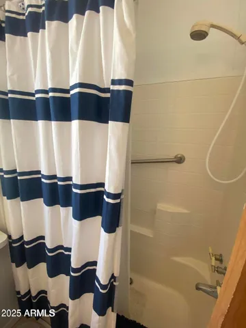 a bathroom with a bathtub and shower