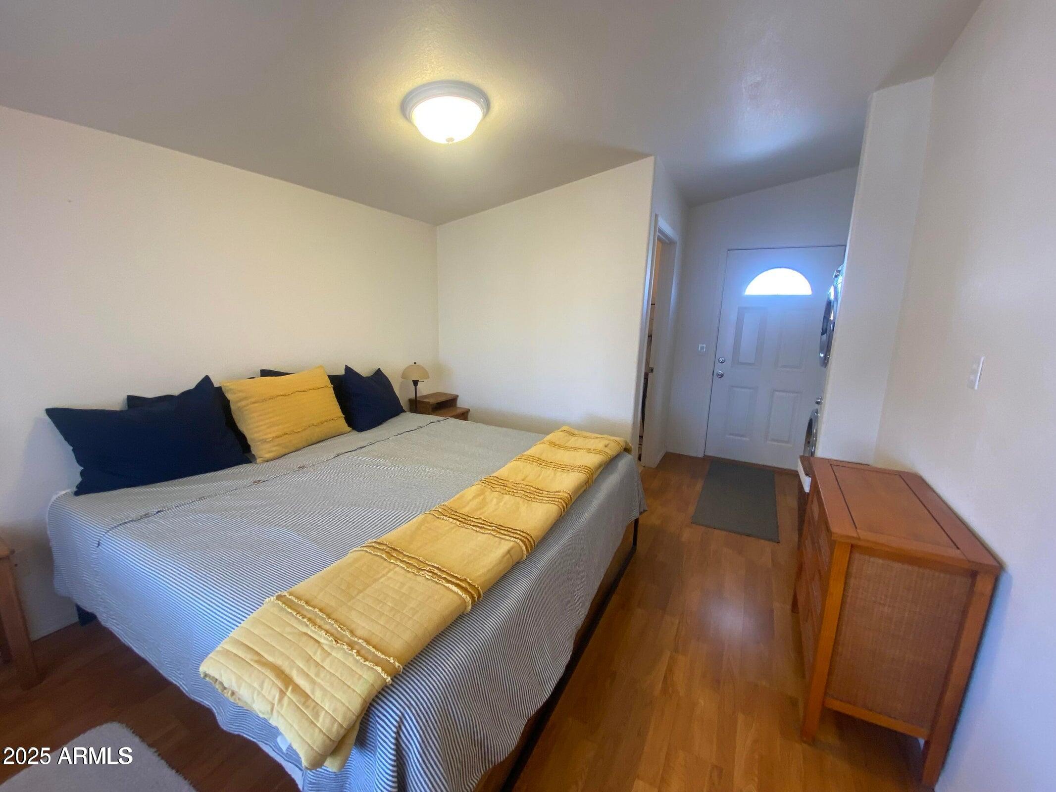 1426 South Havasupai Drive Apache Junction, AZ 85119 - Photo 20 of 32 a bedroom with a bed and wooden floor