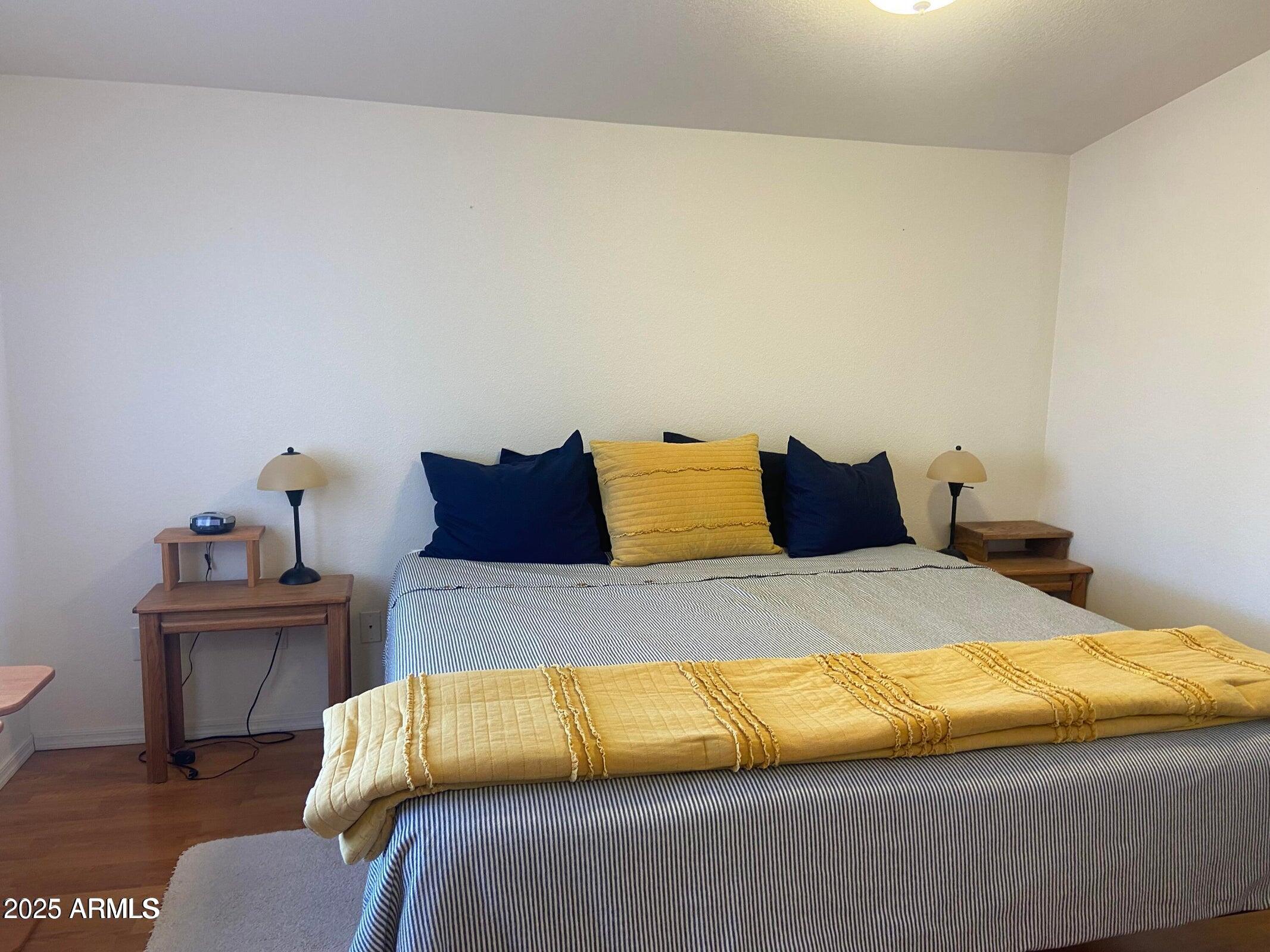 1426 South Havasupai Drive Apache Junction, AZ 85119 - Photo 21 of 32 a bedroom with a bed and wooden floor