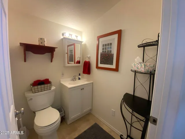 a bathroom with a toilet a sink and mirror