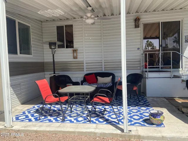 a building outdoor space with patio furniture and potted plants