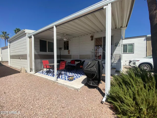 a view of a patio with table and chairs potted plants with wooden fence