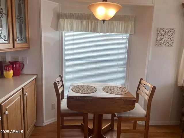 a view of a dining room with furniture and wooden floor