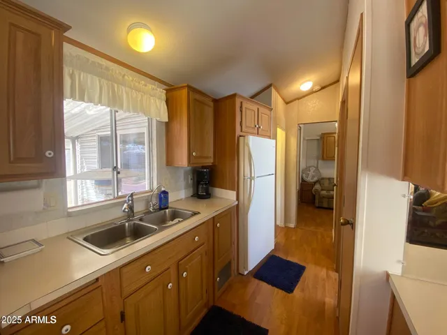 a kitchen with a sink a counter top space and stainless steel appliances
