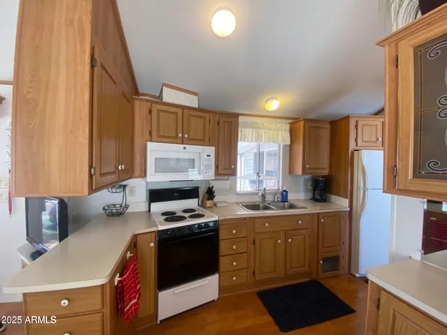 a kitchen with a sink a stove and cabinets